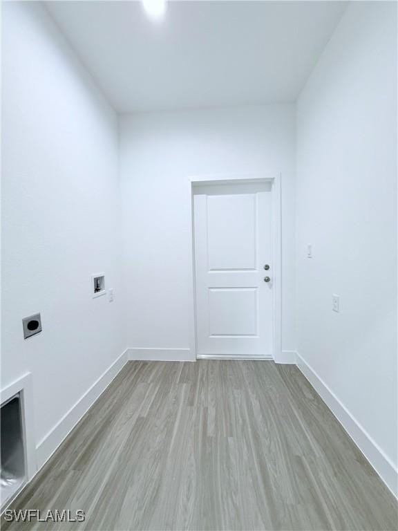 washroom featuring baseboards, washer hookup, wood finished floors, and hookup for an electric dryer