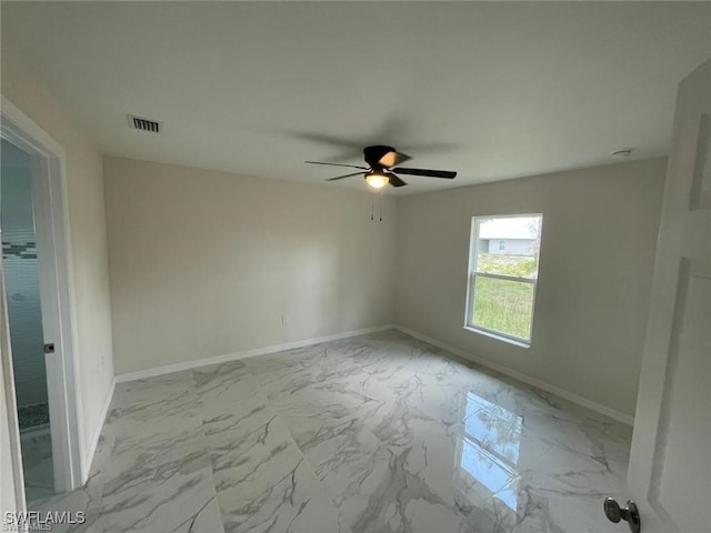 4709/4711 Leonard Blvd S, Lehigh Acres, FL 33973 - spare room with light marble finish flooring, baseboards, and ceiling fan