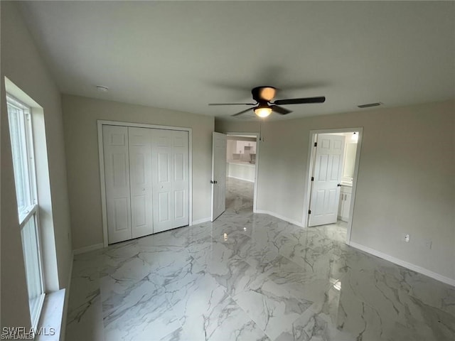 4709/4711 Leonard Blvd S, Lehigh Acres, FL 33973 - unfurnished bedroom featuring baseboards, a closet, marble finish flooring, and a ceiling fan
