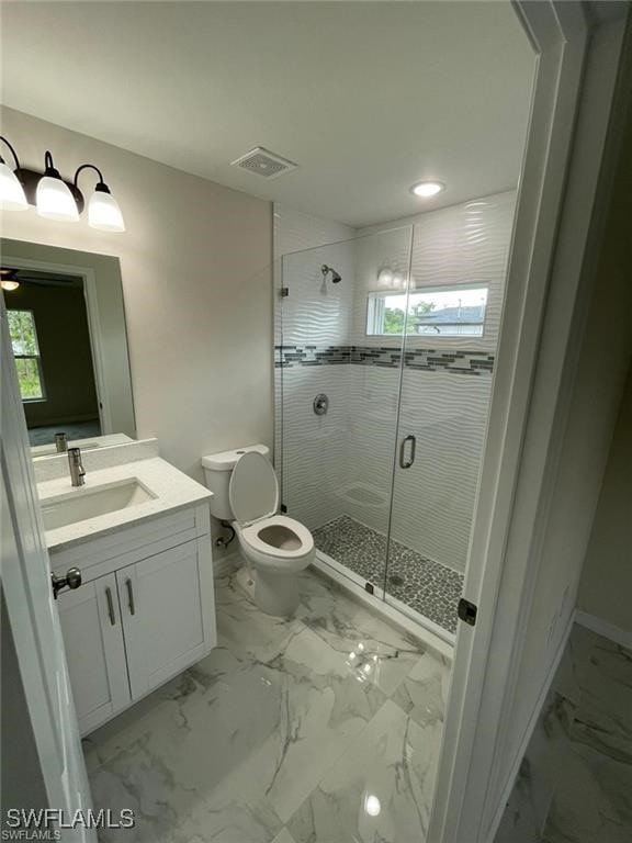 4709/4711 Leonard Blvd S, Lehigh Acres, FL 33973 - bathroom featuring vanity, toilet, a stall shower, marble finish floors, and plenty of natural light