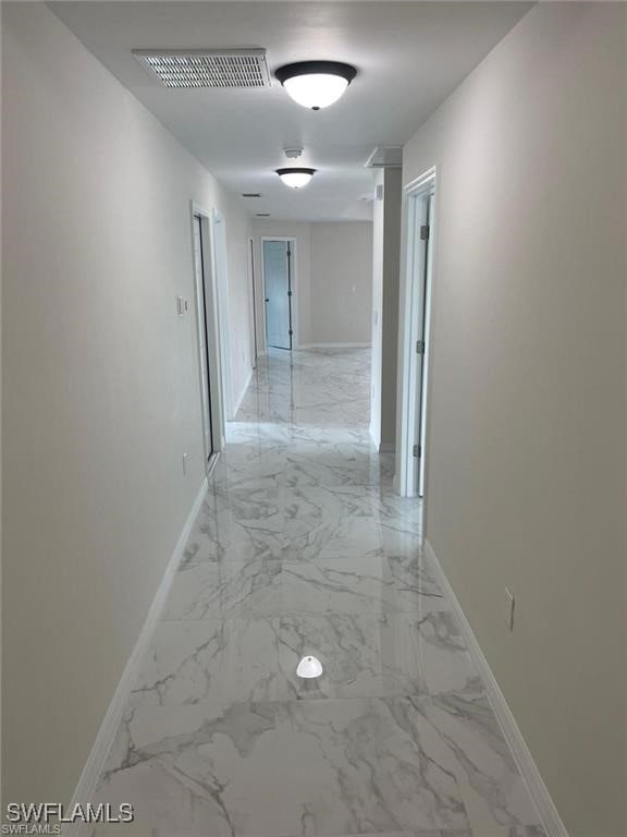 4709/4711 Leonard Blvd S, Lehigh Acres, FL 33973 - hall with baseboards and light marble finish flooring