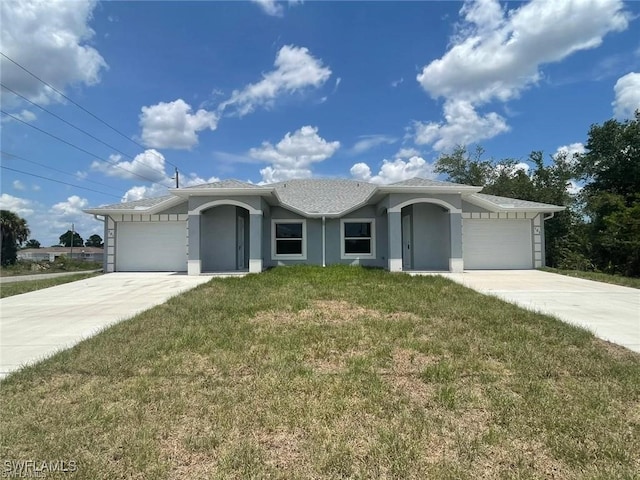 4709/4711 Leonard Blvd S, Lehigh Acres, FL 33973 - ranch-style home with a front lawn, stucco siding, a garage, and driveway