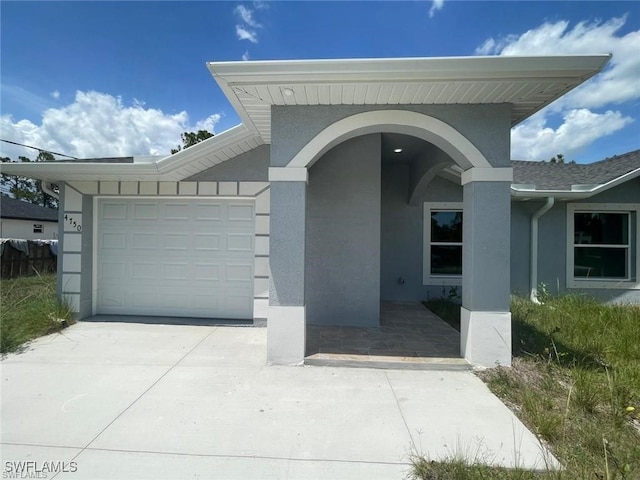 4709/4711 Leonard Blvd S, Lehigh Acres, FL 33973 - view of front of property featuring stucco siding, an attached garage, and driveway