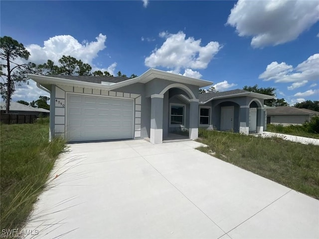 4709/4711 Leonard Blvd S, Lehigh Acres, FL 33973 - ranch-style house with a garage, concrete driveway, and stucco siding