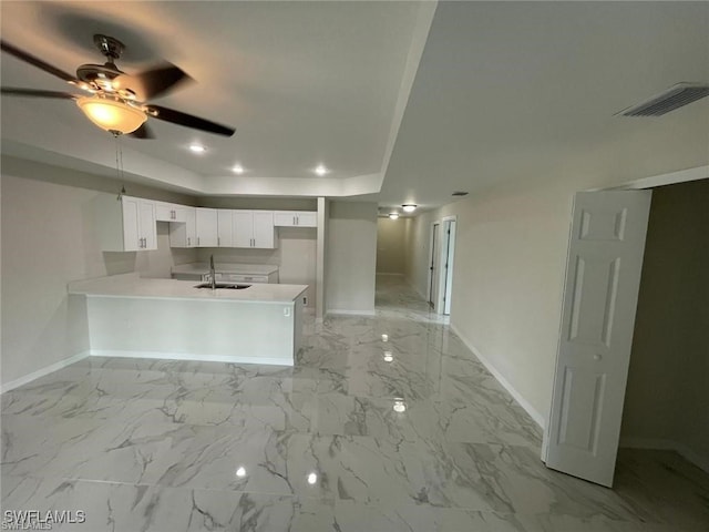 4709/4711 Leonard Blvd S, Lehigh Acres, FL 33973 - kitchen with baseboards, a peninsula, a sink, a tray ceiling, and a ceiling fan