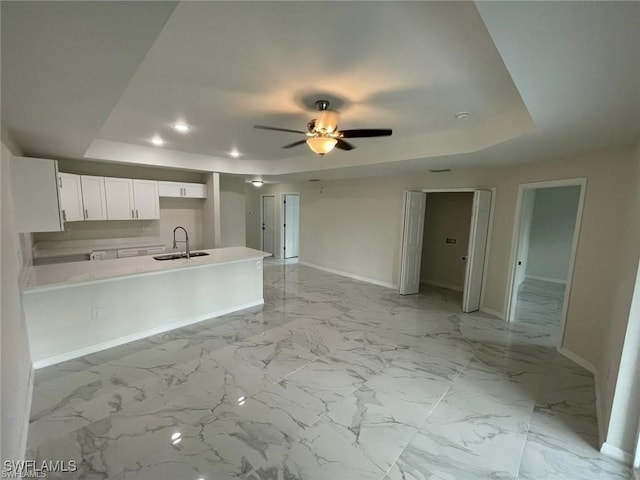 4709/4711 Leonard Blvd S, Lehigh Acres, FL 33973 - kitchen with a tray ceiling, a sink, baseboards, white cabinets, and recessed lighting