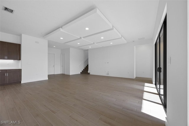 5243 Karlia Dr, Ave Maria, FL 34142 - unfurnished living room with recessed lighting, visible vents, wood finished floors, and stairway