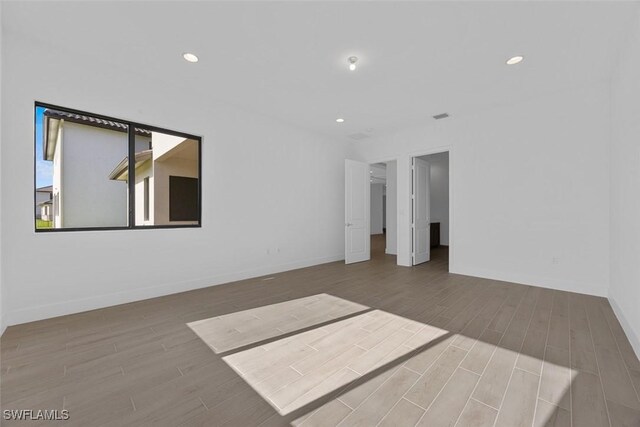 5243 Karlia Dr, Ave Maria, FL 34142 - empty room featuring baseboards, recessed lighting, and wood finished floors