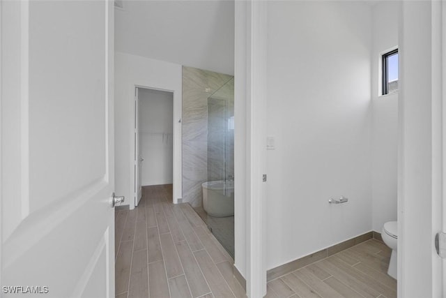 5243 Karlia Dr, Ave Maria, FL 34142 - full bathroom featuring wood tiled floor, a soaking tub, toilet, and a shower stall