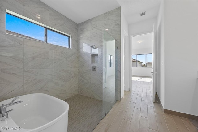 5243 Karlia Dr, Ave Maria, FL 34142 - full bathroom featuring visible vents, a freestanding bath, wood finish floors, a sink, and a walk in shower