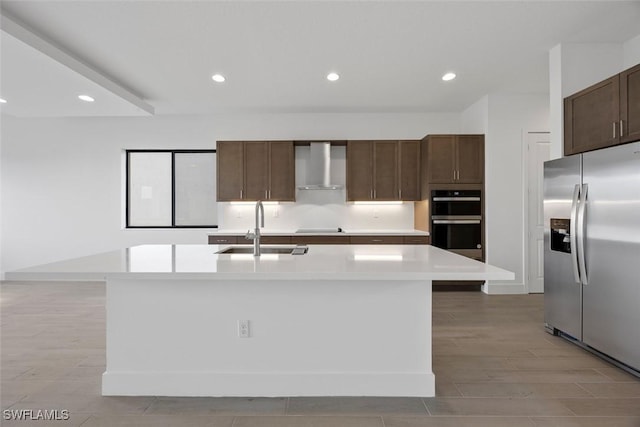 5243 Karlia Dr, Ave Maria, FL 34142 - kitchen with wall chimney range hood, stainless steel fridge, light countertops, a sink, and double wall oven
