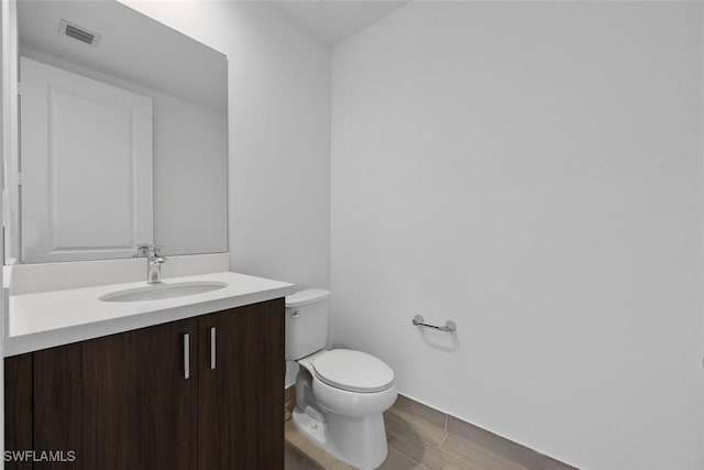 5243 Karlia Dr, Ave Maria, FL 34142 - half bath featuring toilet, baseboards, visible vents, and vanity