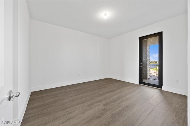 5243 Karlia Dr, Ave Maria, FL 34142 - empty room featuring dark wood-style flooring and baseboards