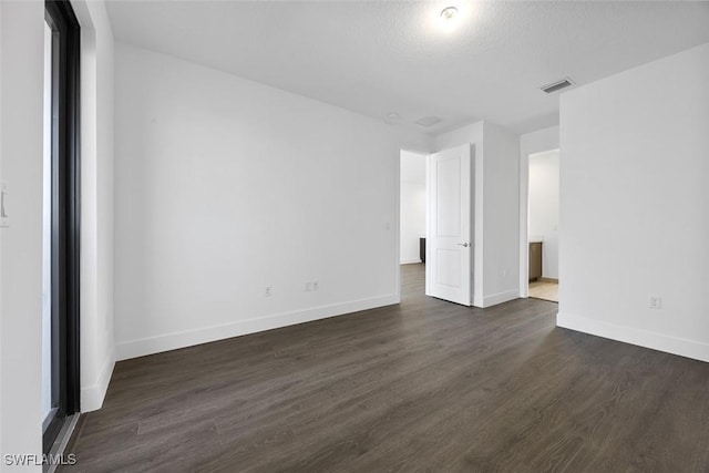 5243 Karlia Dr, Ave Maria, FL 34142 - unfurnished bedroom featuring baseboards, dark wood-style flooring, and visible vents