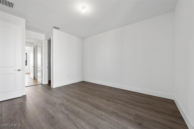 5243 Karlia Dr, Ave Maria, FL 34142 - unfurnished room with baseboards, dark wood-style flooring, and visible vents