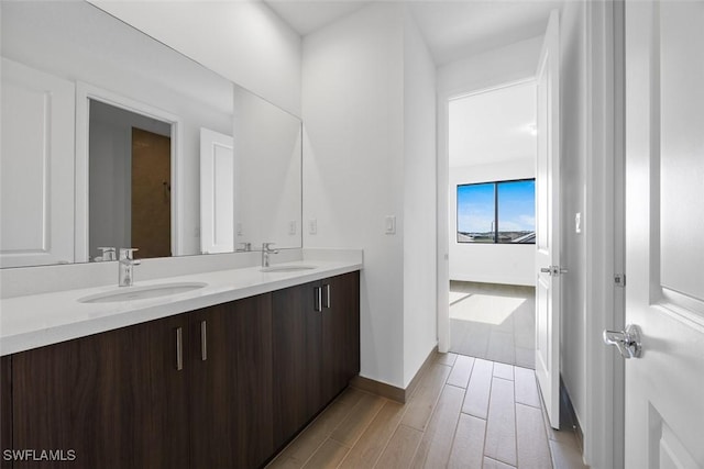 5243 Karlia Dr, Ave Maria, FL 34142 - full bathroom with double vanity, baseboards, a sink, and wood tiled floor