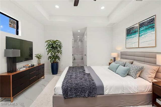 bedroom featuring light marble finish floors, a raised ceiling, recessed lighting, ceiling fan, and connected bathroom