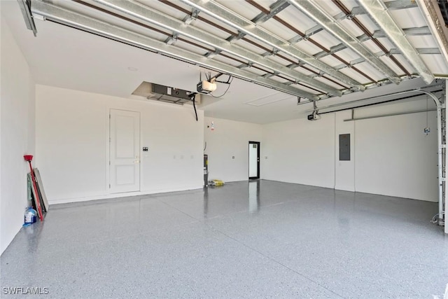 garage featuring electric panel and a garage door opener