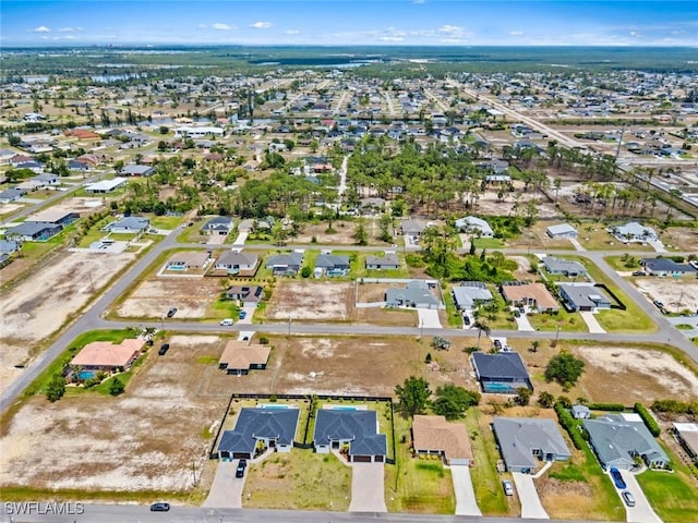 aerial view of property and surrounding area with nearby suburban area
