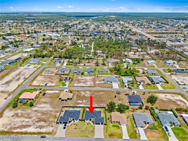 aerial view of property and surrounding area featuring nearby suburban area