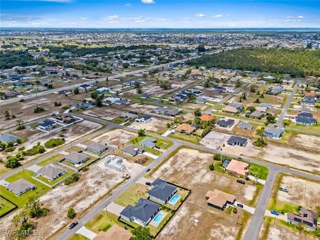 aerial view of property and surrounding area featuring nearby suburban area