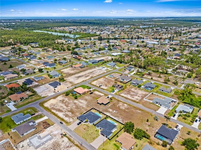 view of property location with a large body of water and nearby suburban area
