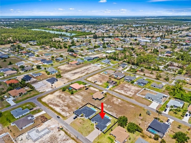 view of property location with a nearby body of water and nearby suburban area