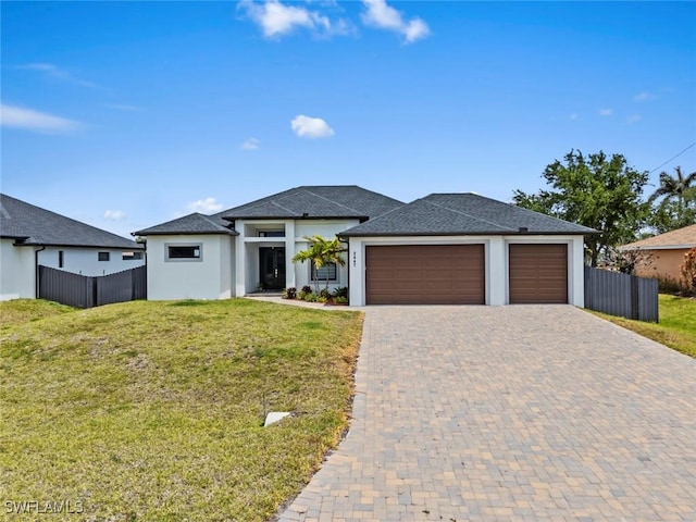 prairie-style home featuring an attached garage, decorative driveway, stucco siding, and roof with shingles