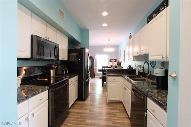 9792 Glen Heron Dr, Bonita Springs, FL 34135 - kitchen with white cabinets, a sink, light wood finished floors, recessed lighting, and black appliances