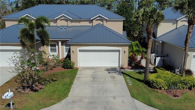 9792 Glen Heron Dr, Bonita Springs, FL 34135 - traditional-style house with an attached garage, stucco siding, metal roof, and concrete driveway