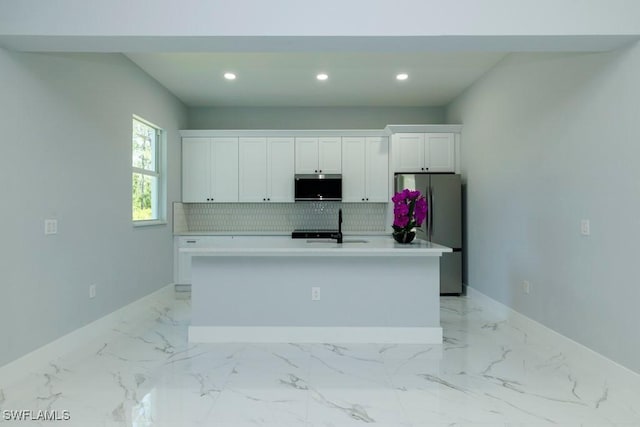 kitchen with freestanding refrigerator, baseboards, white cabinets, and recessed lighting