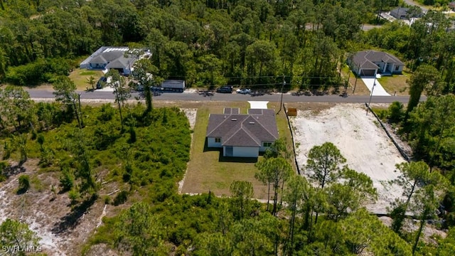 view of subject property featuring a heavily wooded area