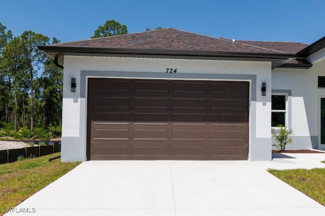 garage with concrete driveway
