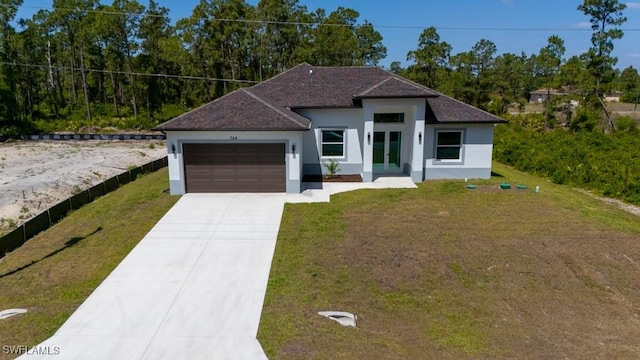view of front of home featuring stucco siding, a garage, driveway, french doors, and a front yard