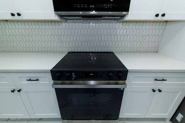 kitchen with range with electric stovetop, white cabinets, tasteful backsplash, and light stone countertops