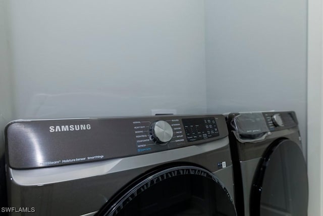 clothes washing area with independent washer and dryer