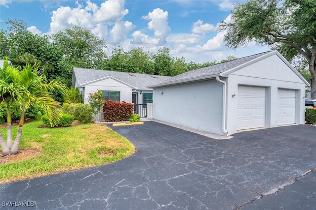4732 Blackberry Dr, Fort Myers, FL 33905 - ranch-style house featuring stucco siding, an attached garage, roof with shingles, and asphalt driveway