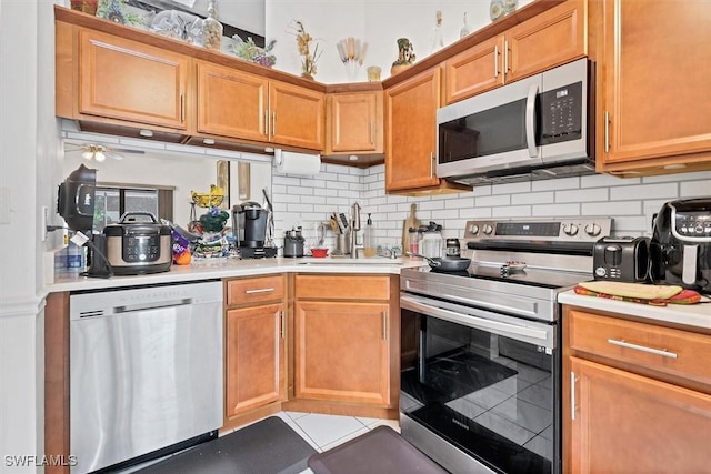 4732 Blackberry Dr, Fort Myers, FL 33905 - kitchen with stainless steel appliances, a sink, light countertops, and decorative backsplash