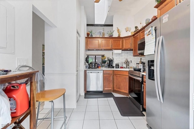 4732 Blackberry Dr, Fort Myers, FL 33905 - kitchen featuring appliances with stainless steel finishes, backsplash, light countertops, a sink, and brown cabinets
