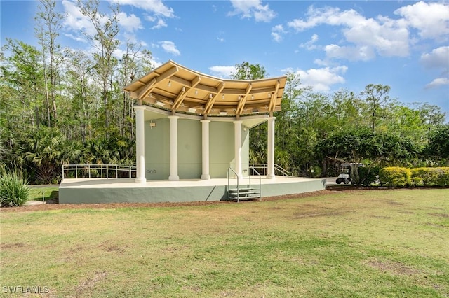 rear view of property with a lawn and stucco siding