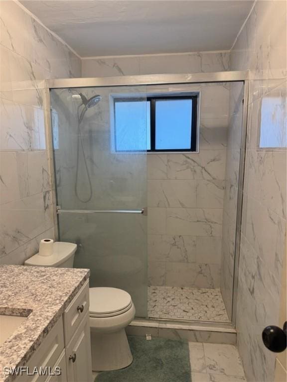 bathroom with vanity, a stall shower, toilet, and marble finish floor