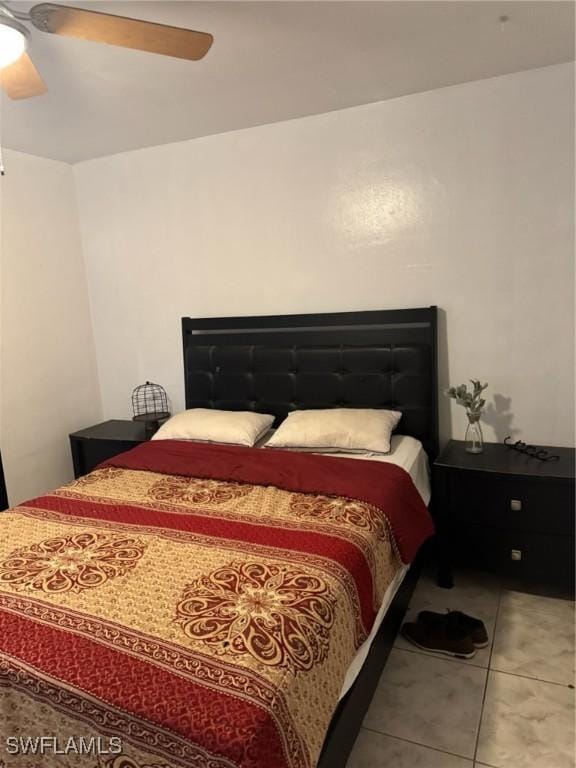 bedroom with a ceiling fan and tile patterned floors