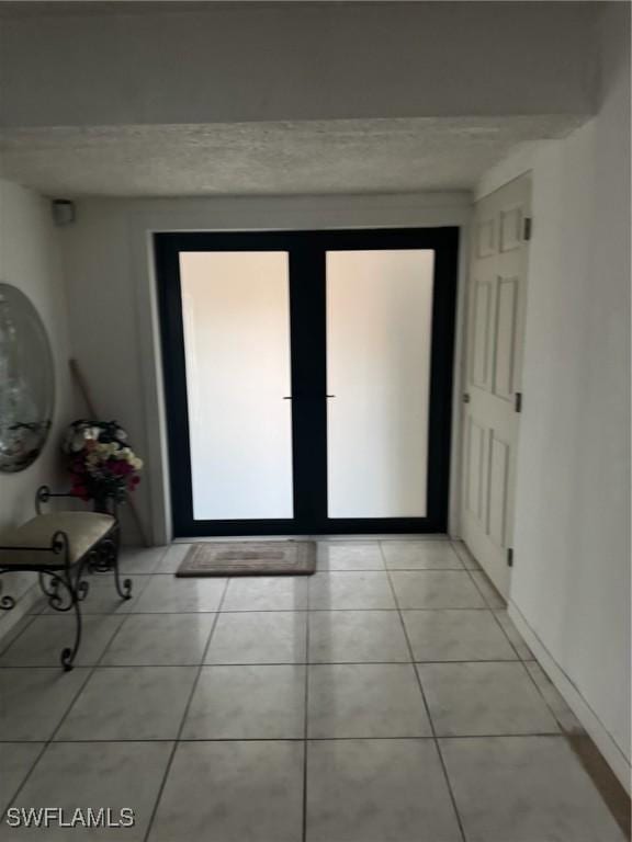 doorway to outside featuring light tile patterned floors
