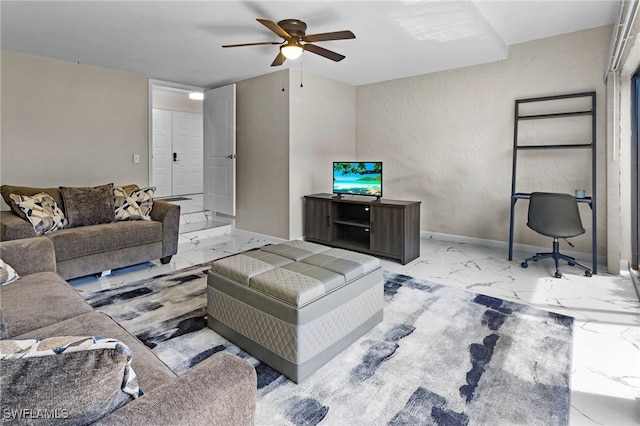 living room featuring baseboards, ceiling fan, and marble finish floor