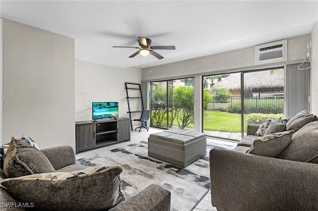 living room featuring ceiling fan and a wall unit AC