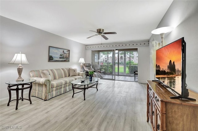 living area with light wood-style floors and ceiling fan