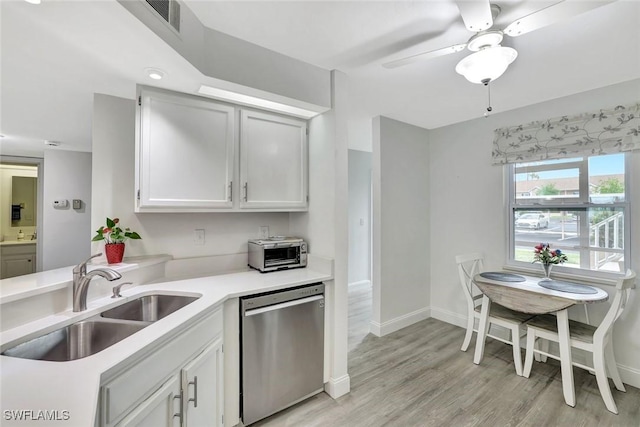 kitchen featuring ceiling fan, a sink, light countertops, baseboards, and stainless steel dishwasher