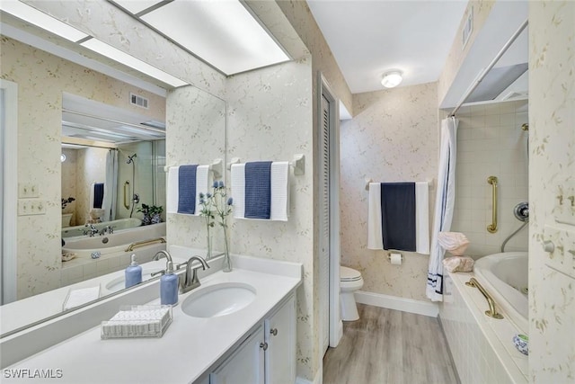 full bath with visible vents, wood finished floors, vanity, toilet, and wallpapered walls