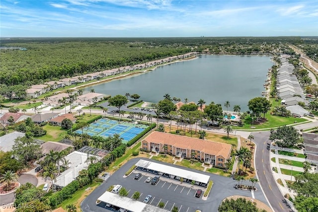 birds eye view of property with a water view and a forest view