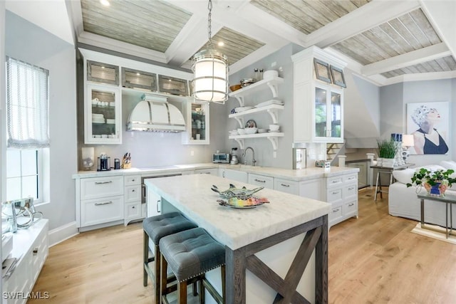 510 2nd St S Unit 102, Naples, FL 34102 - kitchen with healthy amount of natural light, light wood finished floors, open shelves, and wooden ceiling with exposed beams